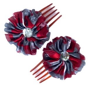 May include: Two red and gray fabric hair combs with rhinestones. The combs are decorated with a red and gray fabric flower.