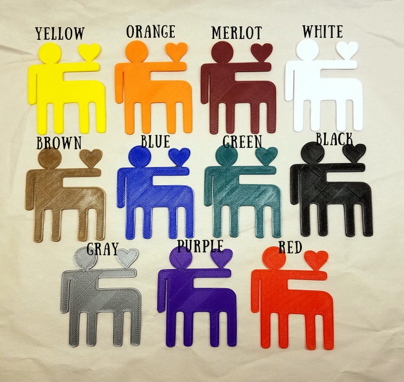May include: A set of 12 3D printed figurines of two people holding a heart. Each figurine is a different color: yellow, orange, merlot, white, brown, blue, green, black, gray, purple, red, and teal.