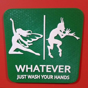May include: Green sign with a white fairy and a white goat playing a flute. The sign says "WHATEVER JUST WASH YOUR HANDS".