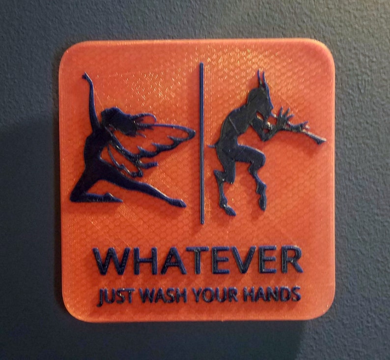 May include: Orange sign with a black silhouette of a winged figure on the left and a horned figure on the right. The sign says "WHATEVER JUST WASH YOUR HANDS".