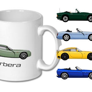 May include: White ceramic mug with a green sports car and the word "Cerbera". The mug also features illustrations of four other sports cars in green, light blue, yellow, and dark blue. A car-themed gift.