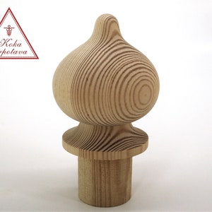 May include: A wooden finial with a rounded top and a base. The finial is made of natural wood with a light brown color and a grain pattern.