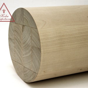 Puede incluir: Primer plano de un cilindro de madera marr&oacute;n claro con una superficie lisa. El cilindro est&aacute; hecho de varias piezas de madera que se han unido.