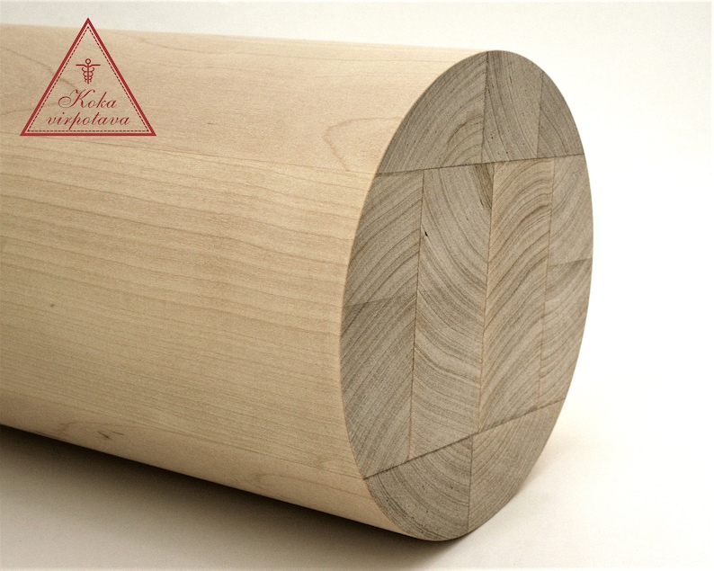 Puede incluir: Primer plano de un cilindro de madera clara con un patr&oacute;n de veta cruzada. El cilindro est&aacute; hecho de varias piezas de madera que se han unido.