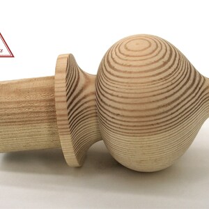 May include: A wooden finial with a rounded, bulbous top and a cylindrical base. The finial is made of light-colored wood with a natural grain pattern.