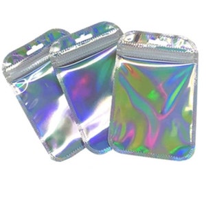 May include: Three iridescent clear plastic zippered bags with a hanging hole at the top.