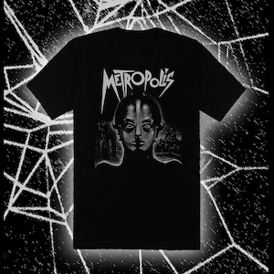 May include: Black t-shirt with a silver print of a robot face and the word "METROPOLIS" above it.