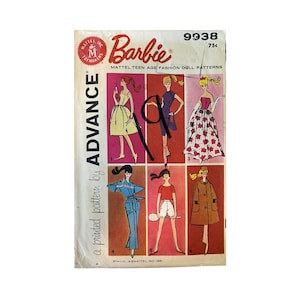 May include: A vintage Advance Barbie sewing pattern envelope, number 9938, featuring six illustrated fashion doll outfits in various colors. The white paper cover displays the Barbie logo, Mattel branding, and a handwritten black ink mark.