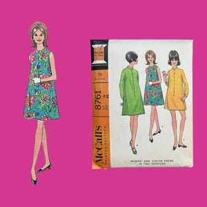 May include: Vintage McCall's sewing pattern for a Misses and Junior dress in two versions. The pattern envelope features illustrations of the dress designs in green, floral, and yellow. A drawing of a woman wearing a floral dress is also shown.
