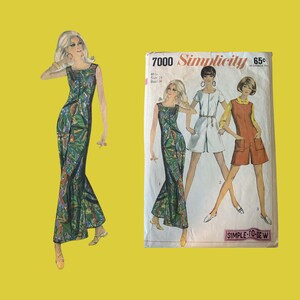 May include: A vintage Simplicity 7000 sewing pattern envelope featuring illustrations of three different outfits, including a floor-length sleeveless dress with a green, blue, and yellow abstract print, a white short jumpsuit, and a rust-colored romper.