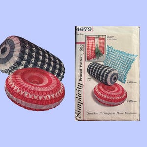 May include: Three decorative pillows in the image. One is a red and white round pillow. Another is a black and white cylindrical pillow. The third is a black and white round pillow. A vintage Simplicity pattern is also in the image.