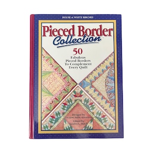 May include: A hardcover book titled Pieced Border Collection by House of White Birches. The cover features a dark blue border with white dots, a red spine, and four triangular quilt pattern illustrations in red, green, blue, and yellow.