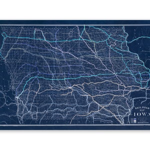 May include: A vintage blue and white railroad map of Iowa. The map shows the state's rail lines and major cities. The title "Railroad Map of Iowa" is in the lower right corner.