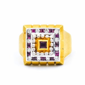 May include: A gold ring featuring a square-shaped centre stone surrounded by smaller stones. The centre stone is a deep purple, while the surrounding stones are white and red.