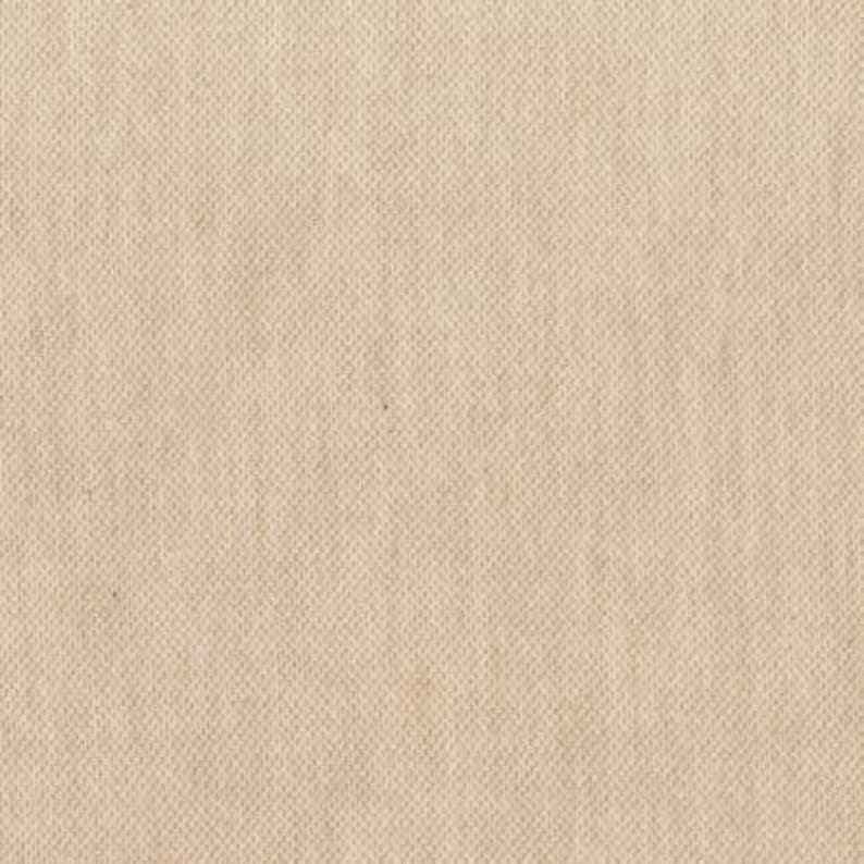 May include: Close-up of a beige woven fabric with a textured, grid-like pattern. The fabric has a neutral colour and a slightly rough appearance, suggesting a natural material like linen or canvas. The weave is tight and consistent.