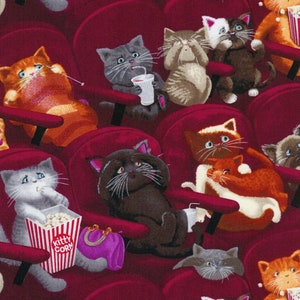 May include: A fabric pattern featuring various cats sitting in red theater seats. The cats are depicted eating popcorn from containers labeled Kitty Corn, drinking from cups, and holding purple purses. The background is a deep red color.