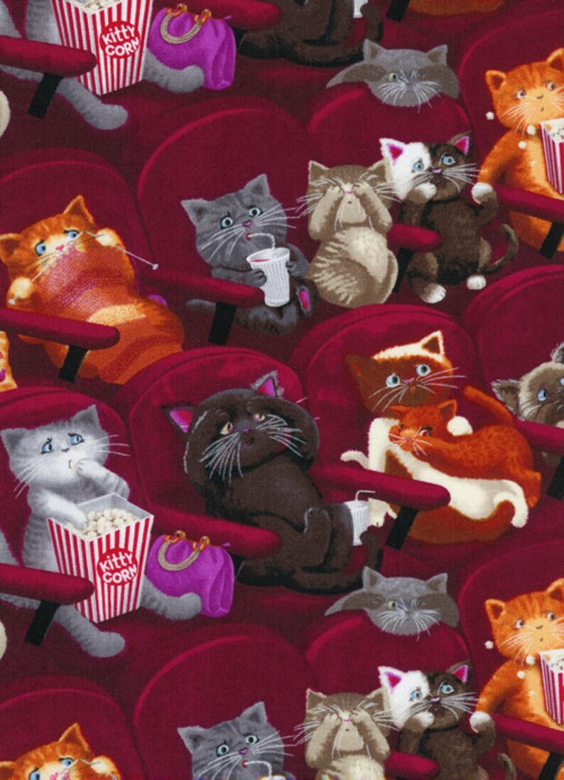 May include: A fabric pattern featuring various cats sitting in red theater seats. The cats are depicted eating popcorn from containers labeled Kitty Corn, drinking from cups, and holding purple purses. The background is a deep red color.