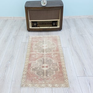 Entrance doors decorated with traditional Turkish motifs, Muted small old rug for the bathroom