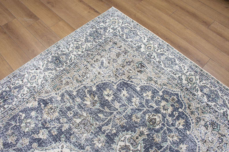May include: A blue and cream patterned rug with a traditional design. The rug has a detailed floral pattern with a central medallion.