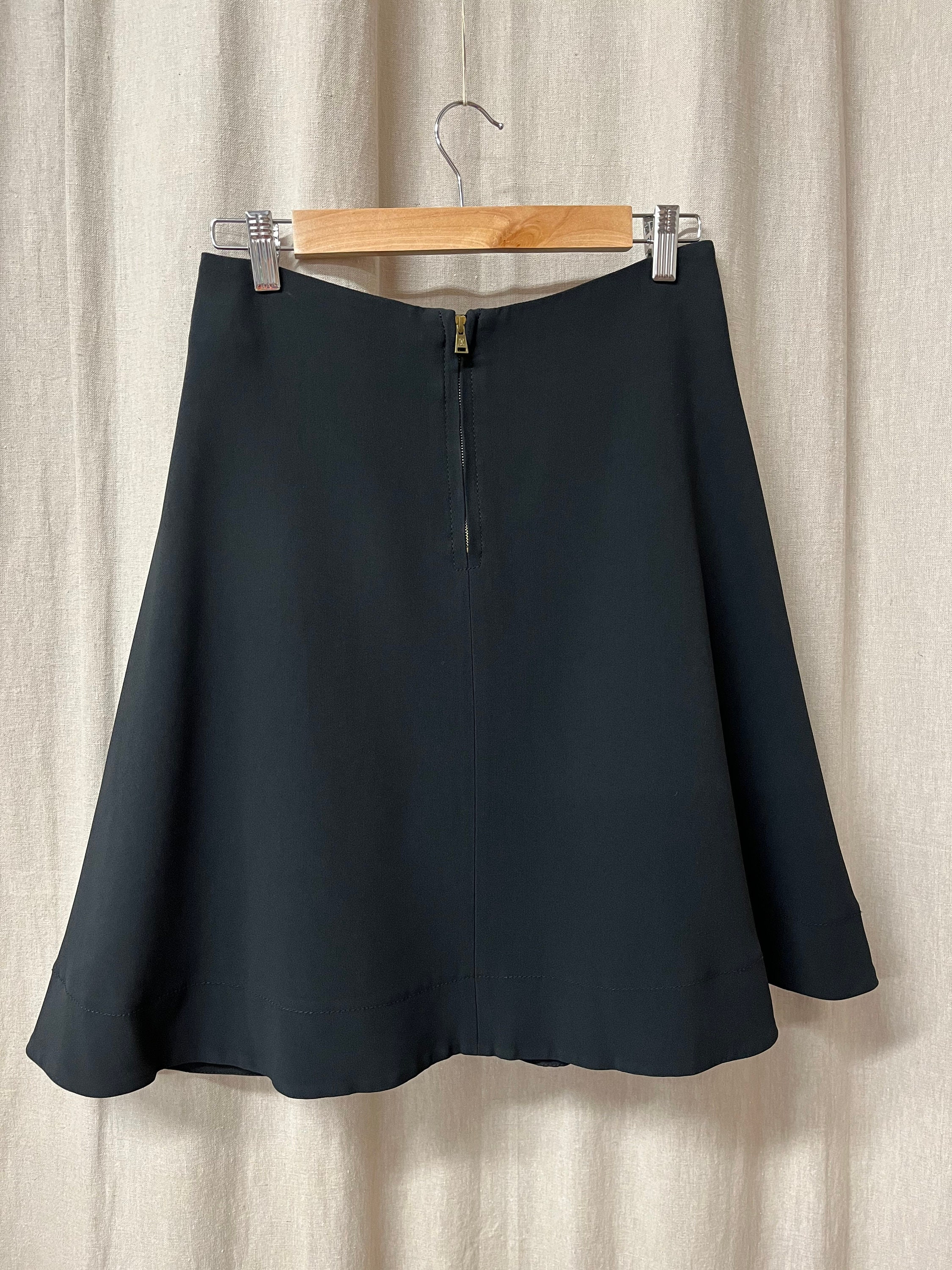 black pleated skirt white sweater louis vuitton bag street…