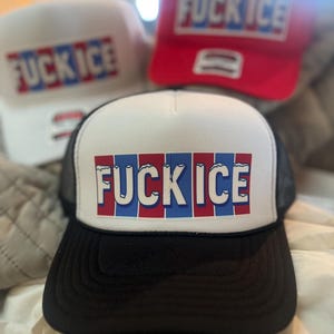 May include: Three trucker hats with the text "FUCK ICE" in red, white, and blue block letters. The hats are white, red, and black with a mesh back.