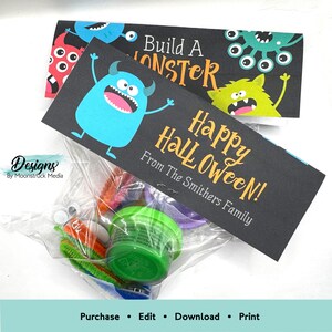 May include: A black and orange Halloween treat bag with a monster-themed tag that says "Happy Halloween!" and "Build A Monster" with a blue monster on the front. The tag is from "The Smithers Family".