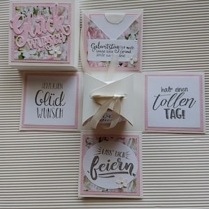 Könnte beinhalten: Eine handgefertigte, mehrteilige Grußkarte mit floralem Design und rosa Akzenten. Die Karte enthält deutschen Text, darunter "Glückwunsch", "Geburtstag" und "feiern". Die Karte ist mit kleinen Papierblumen und einem Band verziert.