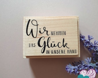 Wooden stamp "wir nehmen das Glück in unsere Hand"