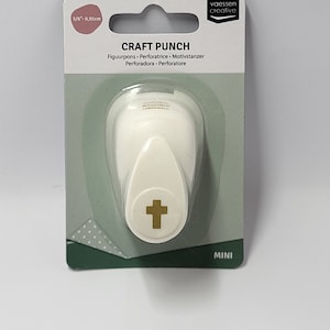 May include: White craft punch with a gold cross design. The punch is labelled "CRAFT PUNCH" and "MINI".