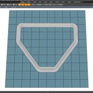 May include: A white plastic cookie cutter shaped like a diamond. The cutter has a double layer design, creating a raised edge.