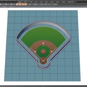 May include: A 3D render of a baseball field cookie cutter. The field is green with a brown infield and a white outline. The background is a light blue grid.
