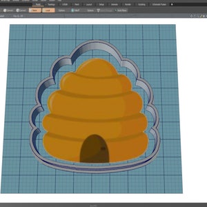 May include: A 3D rendering of a beehive cookie cutter. The cutter is in the shape of a beehive with a scalloped border. The beehive is a golden yellow color with a brown entrance. The background is a light blue grid.