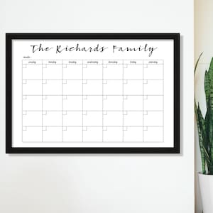 May include: Black framed dry erase calendar with the text "The Richards Family" at the top. The calendar has a grid with the days of the week labeled: Sunday, Monday, Tuesday, Wednesday, Thursday, Friday, Saturday.