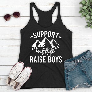 May include: A black tank top with a white graphic that says "Support wildlife raise boys" with a mountain range design.