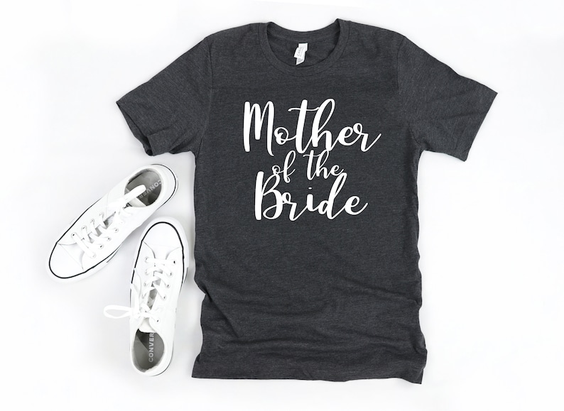 a t - shirt that says mother of the bride next to a pair of sneakers