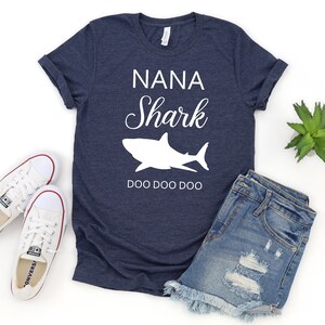 a t - shirt that says nanna shark and a pair of shorts