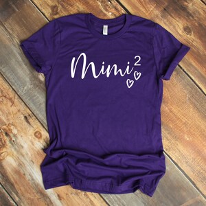 a purple shirt with the word mnnj on it