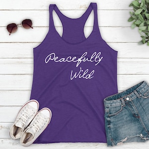 May include: Purple tank top with the text "Peacefully Wild" in white script.