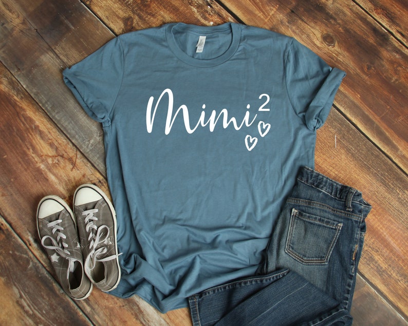 a t - shirt with the word mnnj on it next to a pair