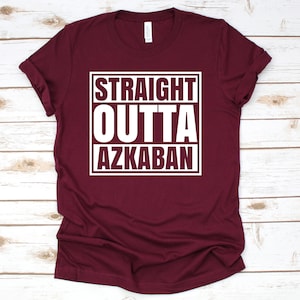 a maroon tshirt with the words straight, outta, azzaba