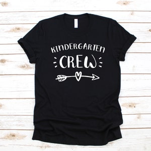 May include: Black t-shirt with white text that says "Kindergarten Crew" with an arrow and heart graphic.