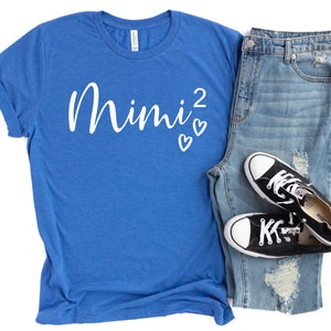 a pair of jeans and a t - shirt with a pair of sneakers