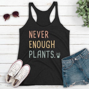 May include: Black tank top with the text "NEVER ENOUGH PLANTS." in colorful letters with a small potted plant graphic.