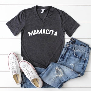 a t - shirt that says mamacita on it next to a pair of