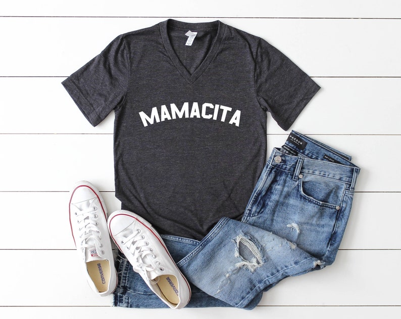 a t - shirt that says mamacita on it next to a pair of