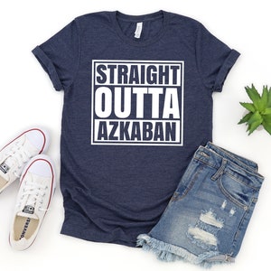 a t - shirt that says straight outa akkaban next to a pair