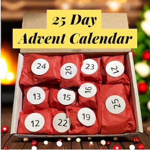 May include: A 25-day Advent calendar in a cardboard box. The box contains red wrapped packages with white circular stickers numbered 12-25. The text "25 Day Advent Calendar" is displayed in yellow above the packages. Christmas themed.