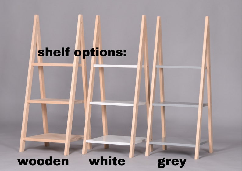 May include: Three wooden A-frame shelves, each with three shelves. The shelves are available in three colors: natural wood, white, and gray. "shelf options:" is written above the shelves.