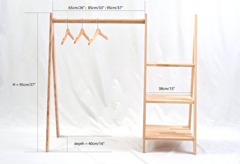 May include: A wooden clothing rack with a shelf unit. The rack is 37 inches tall and 26 inches wide. The shelf unit is 15 inches wide and has three shelves. The rack is made of natural wood and has a rustic look.