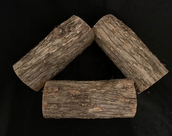 Troncos de madera de hierro, de aproximadamente 6 pulgadas de largo y unas 2 3/4 pulgadas de diámetro.